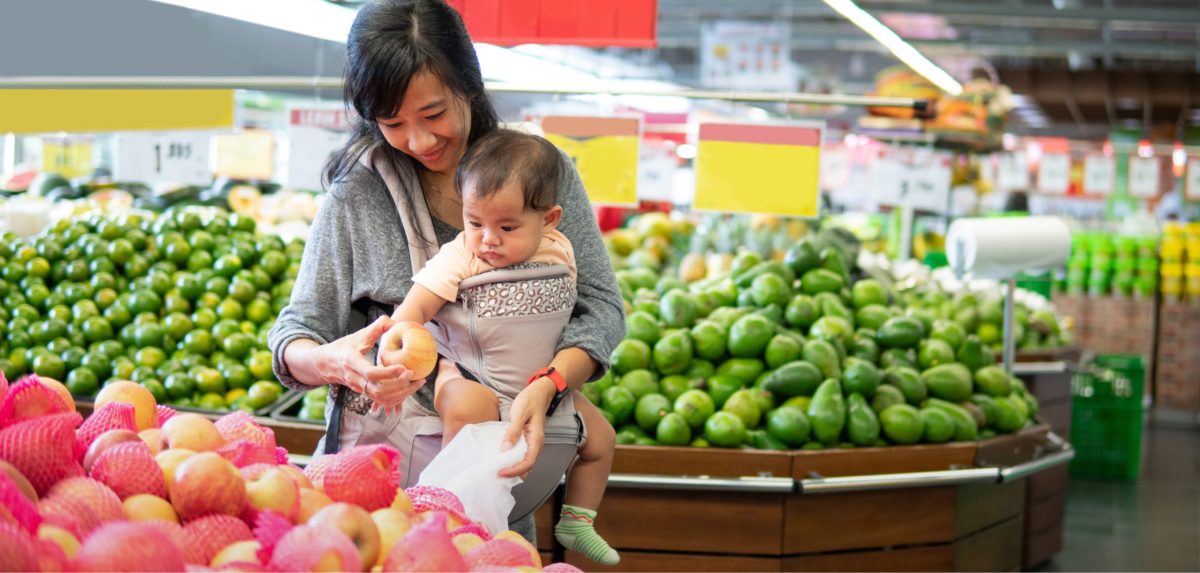 Woman in grocery store with baby